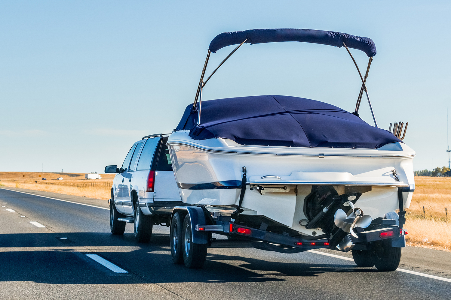 Truck Towing a Boat on the Interstate in California