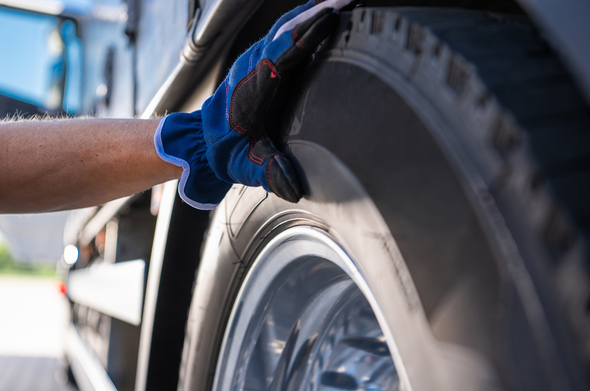 A,Mechanic,In,Gloves,Checks,The,Condition,Of,A,Truck